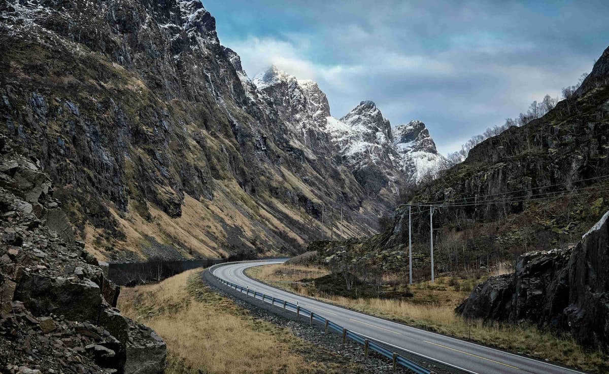 a long road with a mountain in the background