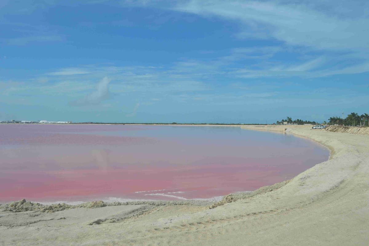 a-large-body-of-water-sitting-on-top-of-a-sandy-beach