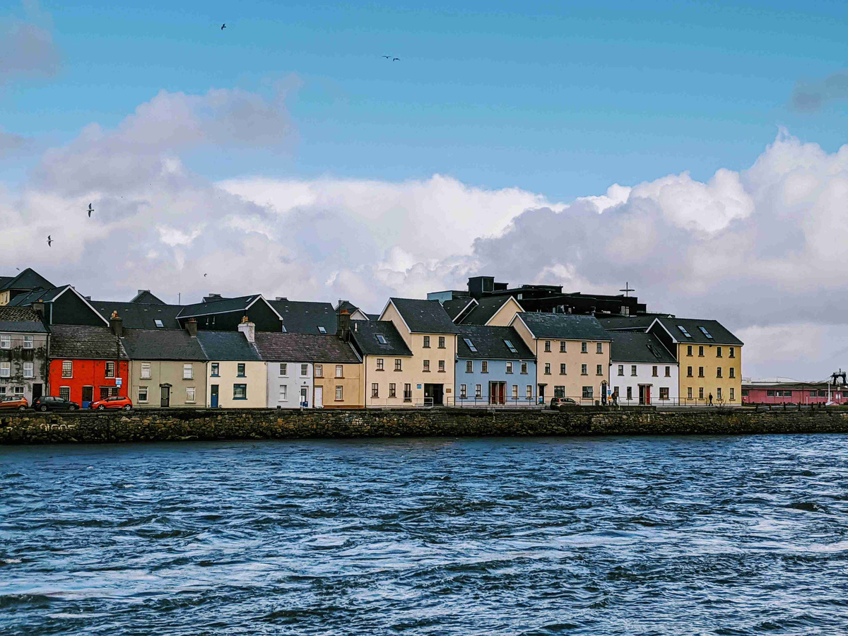 Colorful_Waterfront_Houses_with_Cloudy_Sky