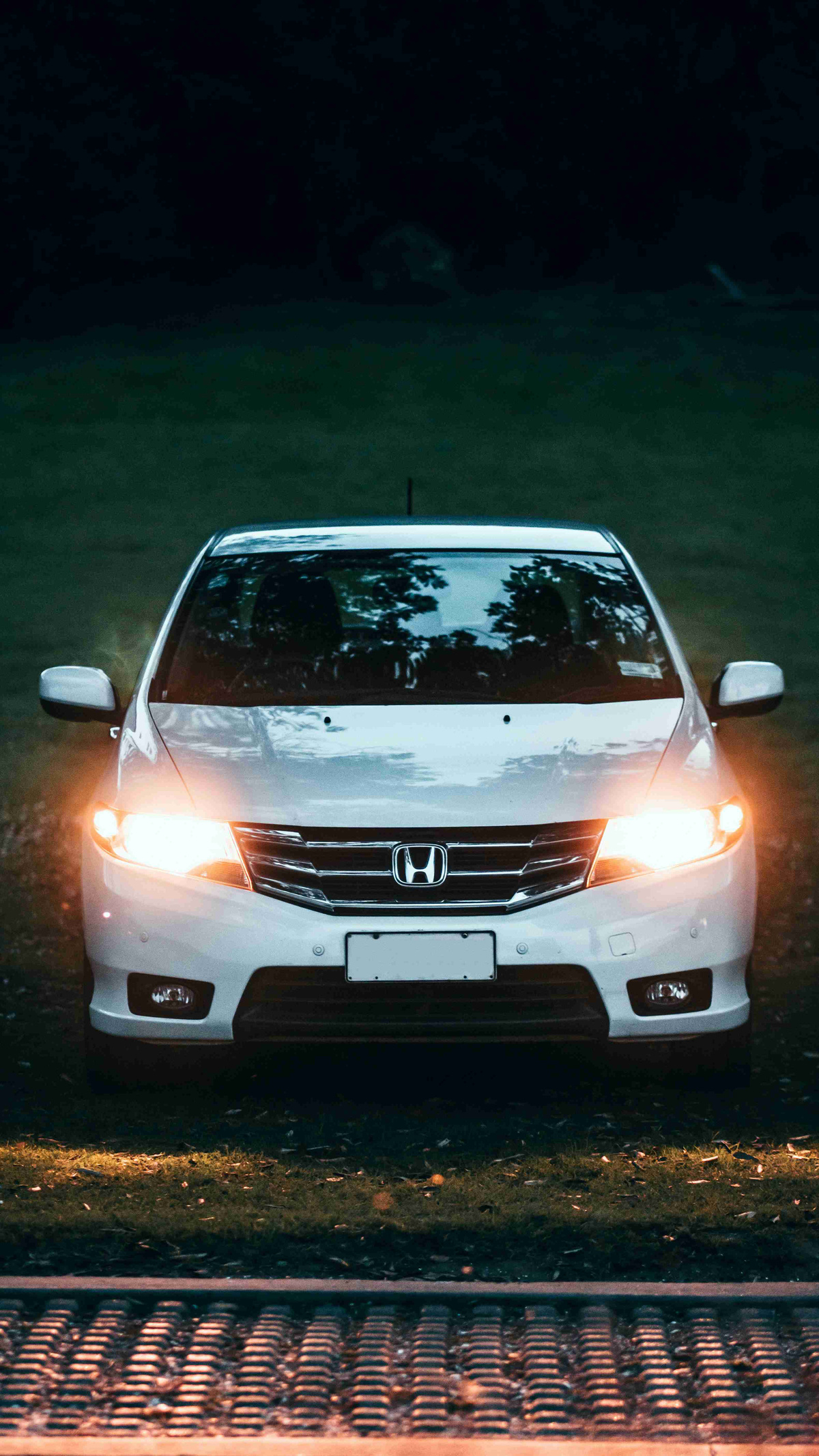 Honda_Sedan_Headlights_Illuminated_At_Dusk