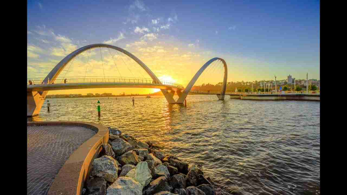 Sunset_Over_Modern_Arch_Bridge_by_the_River