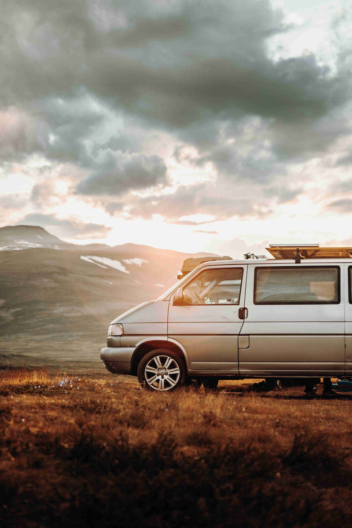 Van_Parked_in_Mountainous_Landscape_at_Sunset