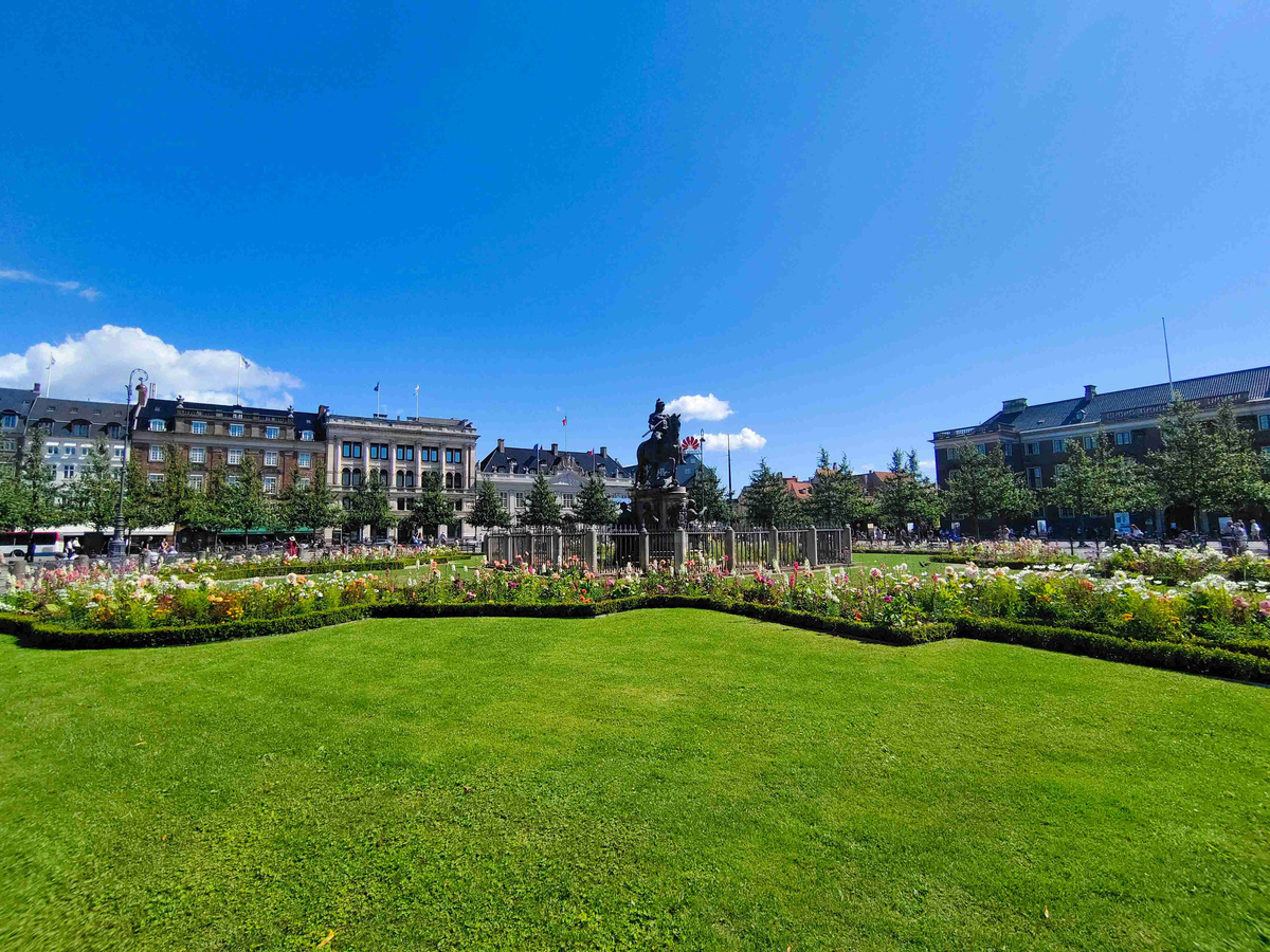 Vibrant_City_Park_with_Floral_Display_and_Sculpture